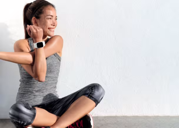 woman stretching with device on wrist