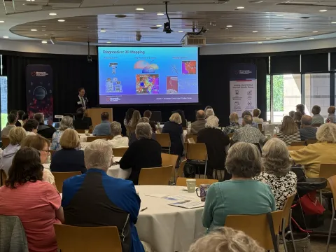 A room full of attendees at a community education event
