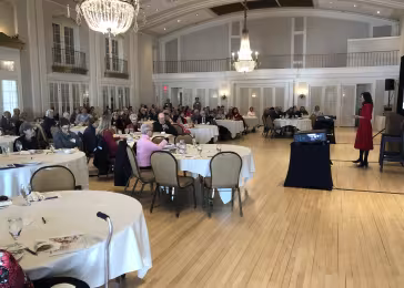 Dr. Nadira Hamid speaking to a room full of people